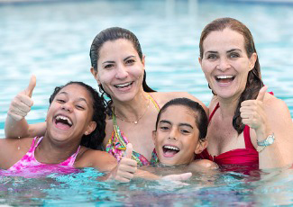 family playing in water