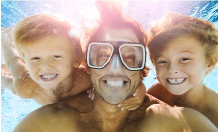 dad and two boys in pool