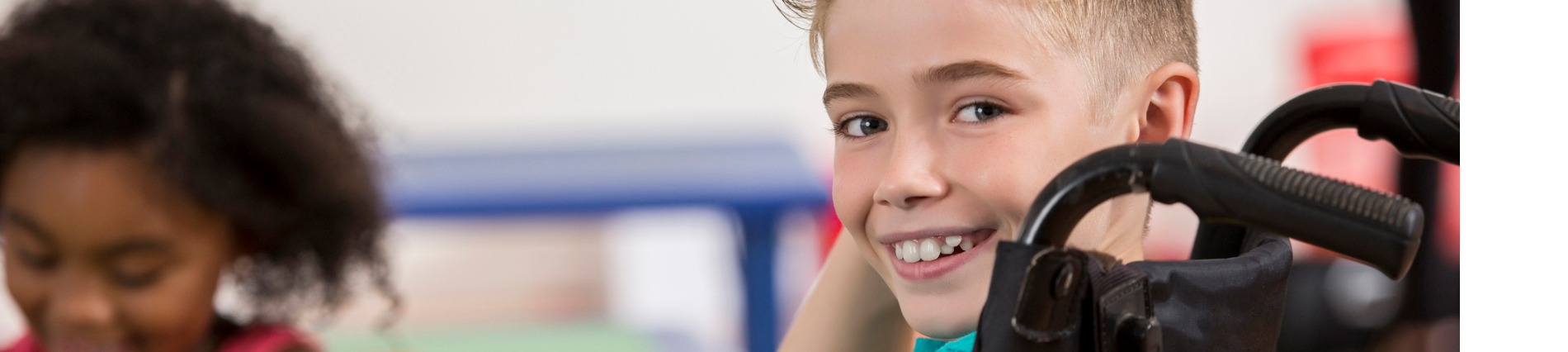 smiling boy in wheelchair