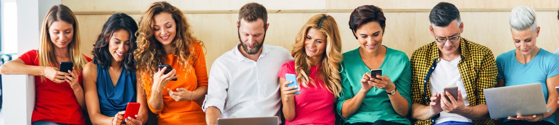 various people looking at devices