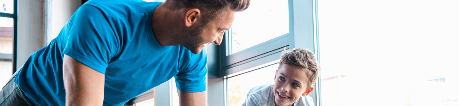 happy father with son exercising with dumbbells