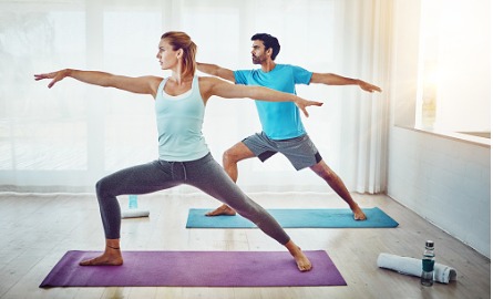 Male and female doing yoga