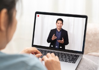 lady watching a speaker on her laptop