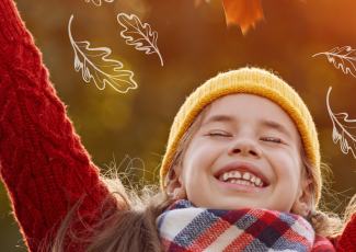 Child looking up into a fall background scene