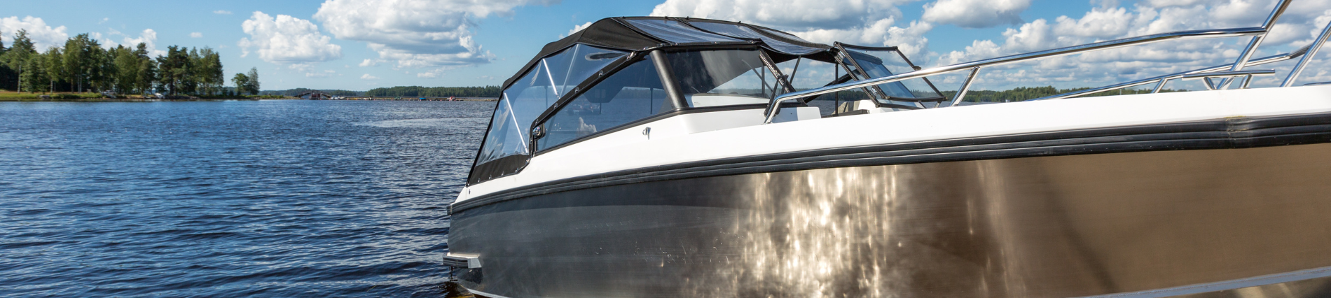 Picture of a lake with a close up boat in the right side foreground