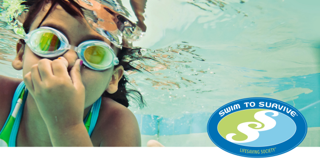 Close up of child's face swimming in a pool with goggles and plugging nose under water.
