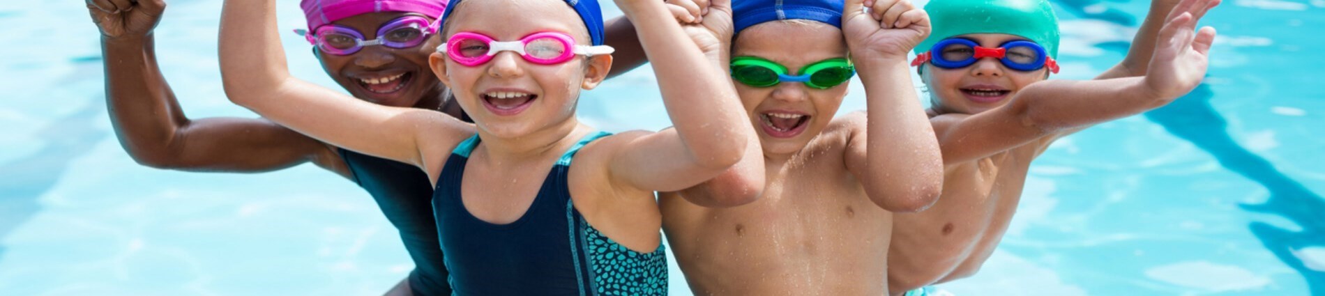 children swimming underwater in pool