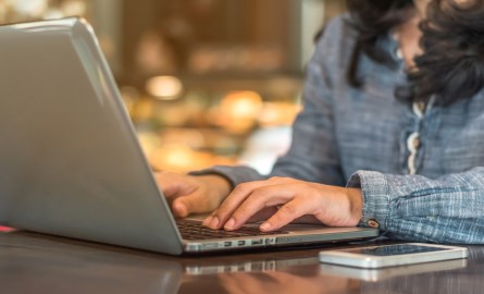 Female typing on a computer.